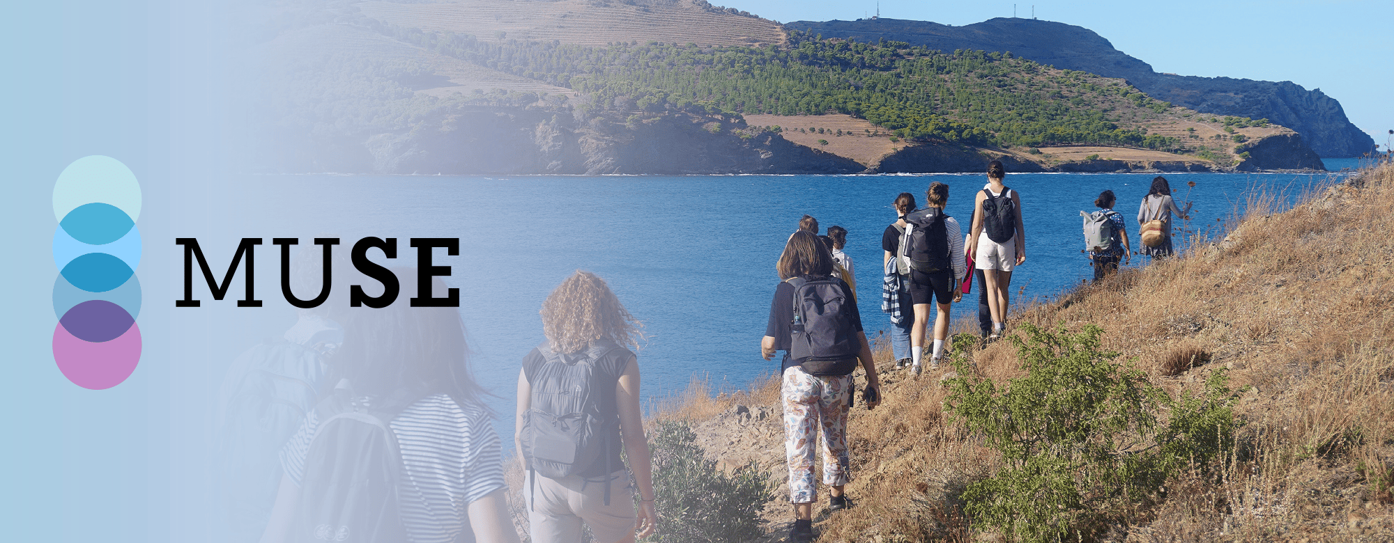 Students walking along a coastal path during a field activity.